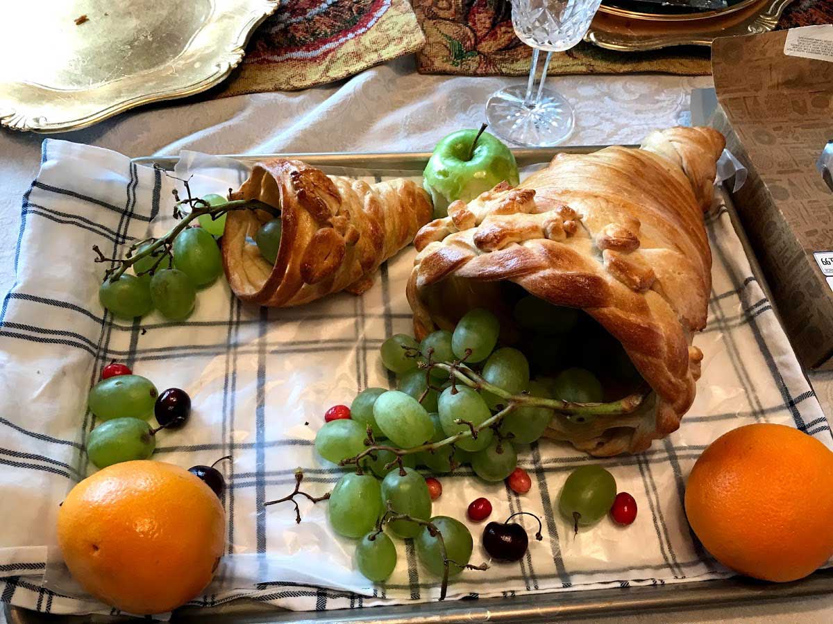 Two cornucopias filled with fruit