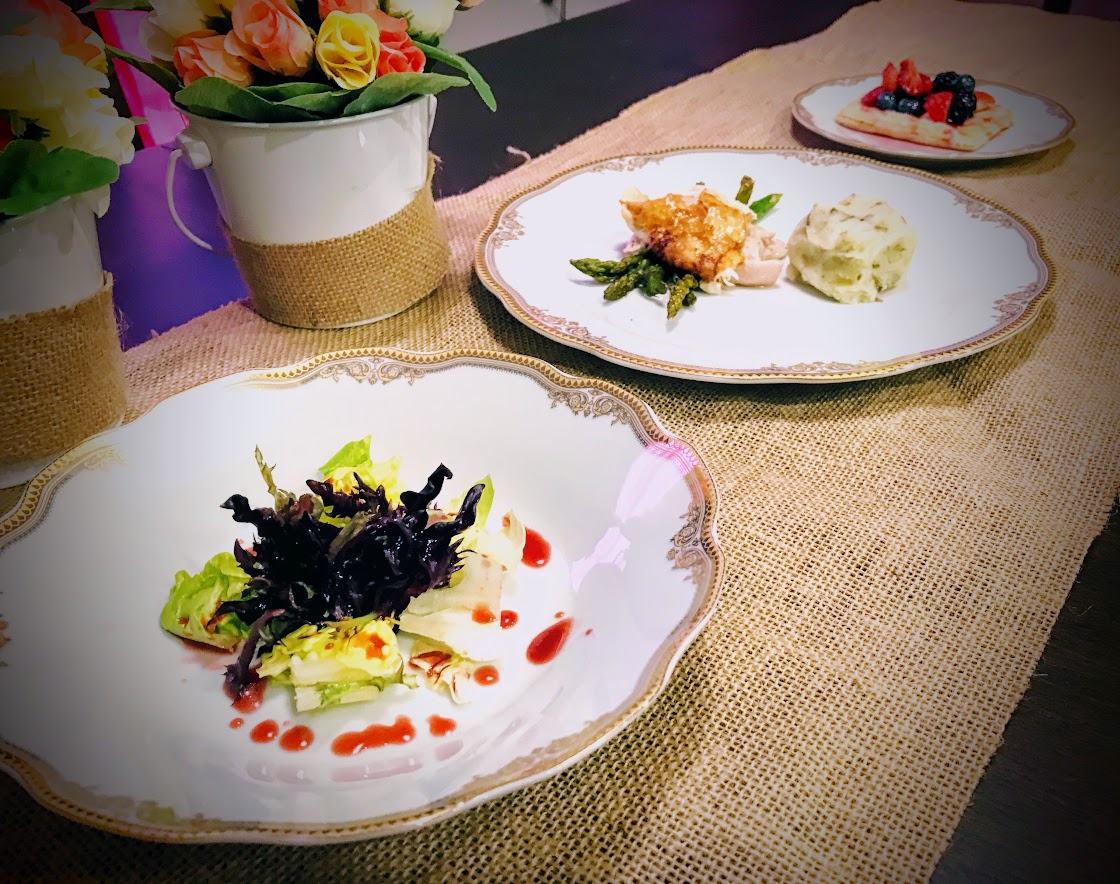 Three plates with three courses(Salad, Chicken, and Fruit and pastry)